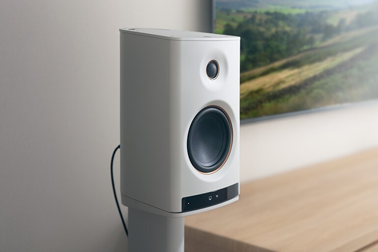 Close‑up of the NX‑70A speaker beside a TV
