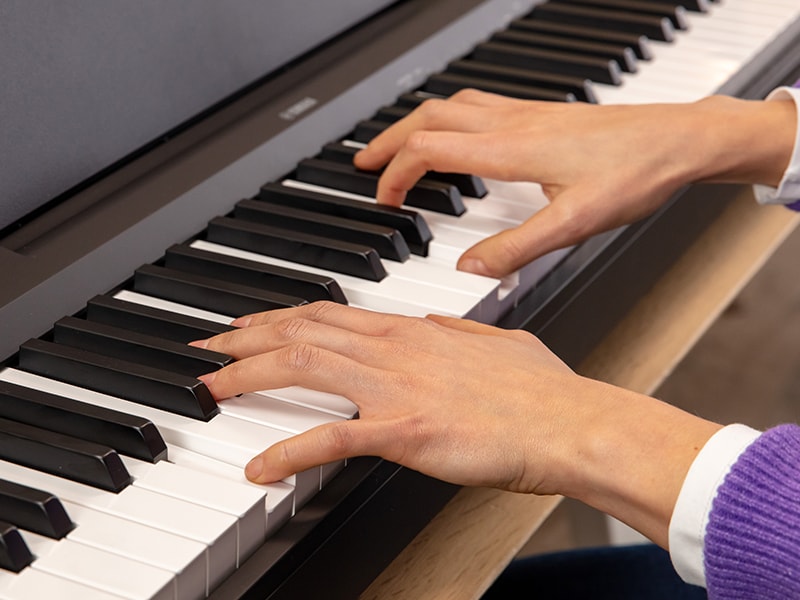 The hands of a person playing the P-145BT