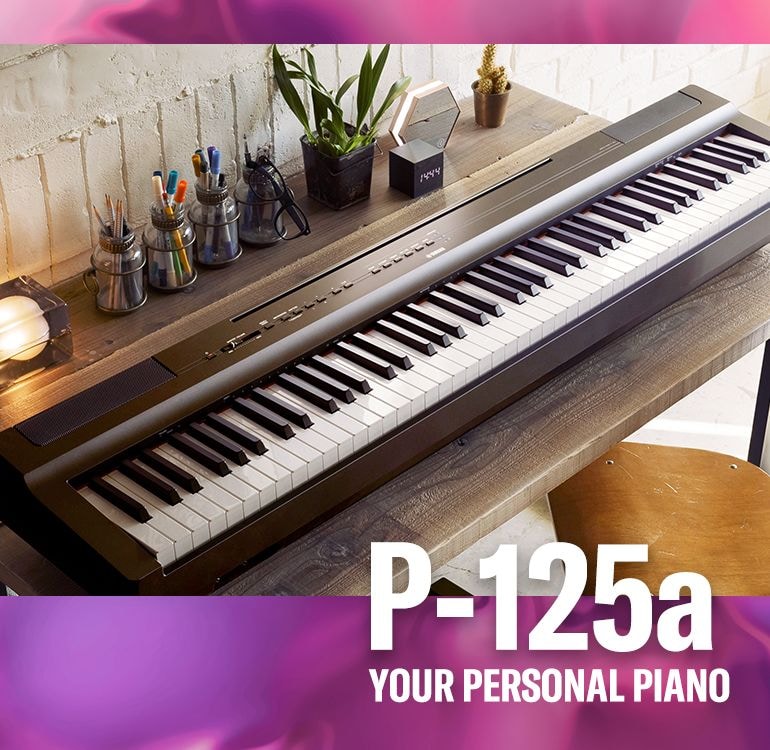 A photo of a Yamaha P-125a digital piano on a desk
